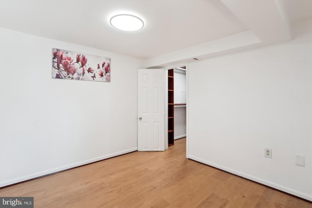 spare room with wood-type flooring