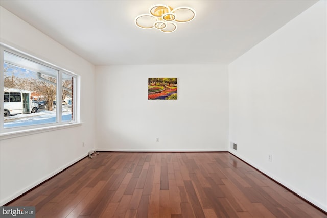 empty room with hardwood / wood-style floors