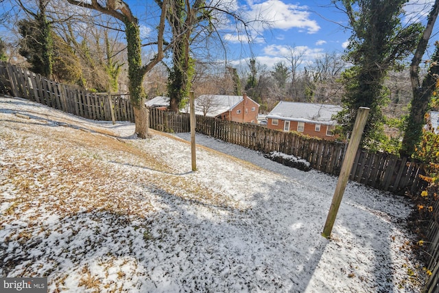 view of yard layered in snow