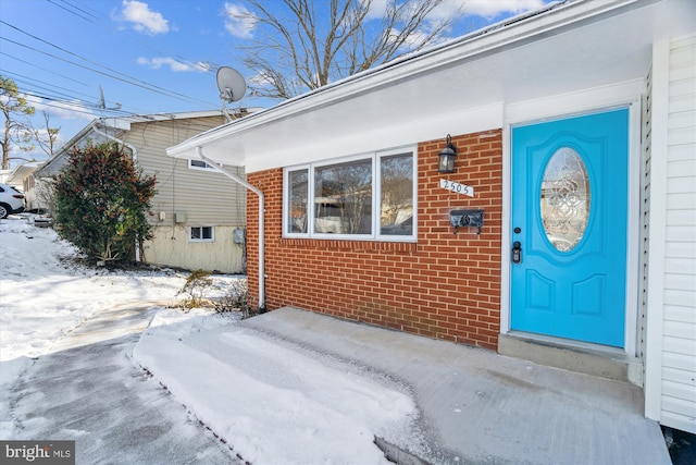 view of snow covered property entrance