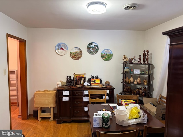 dining space with light hardwood / wood-style flooring