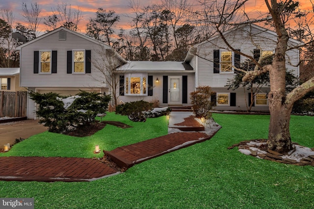 split level home with a lawn