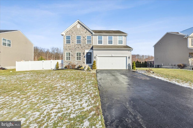 view of front of property with a garage and a front yard