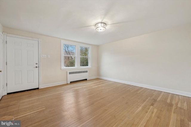 interior space with light hardwood / wood-style floors and radiator heating unit