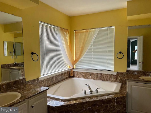 bathroom with a relaxing tiled tub and vanity