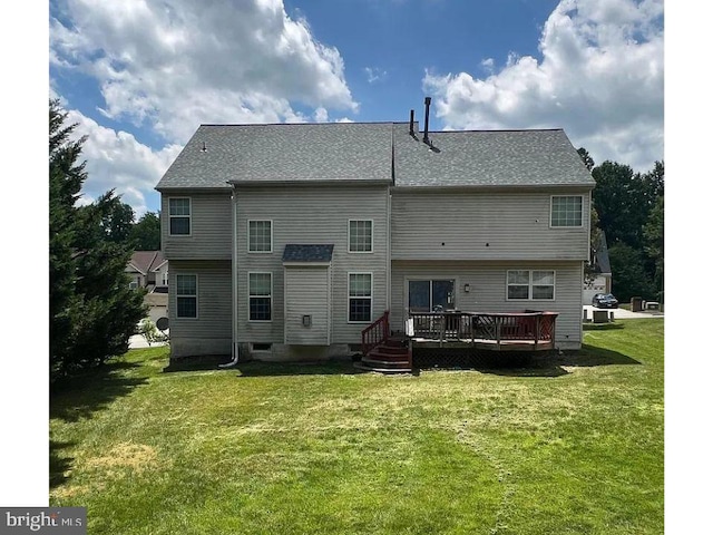 rear view of house featuring a deck and a yard