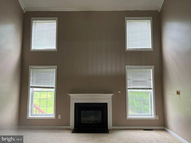 unfurnished living room featuring light carpet and ornamental molding