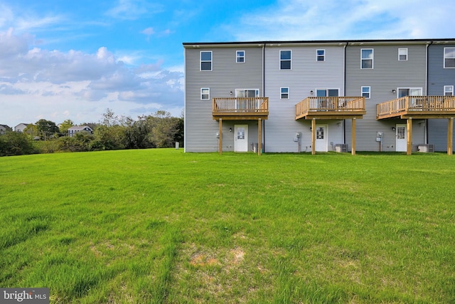 back of house with a lawn and cooling unit