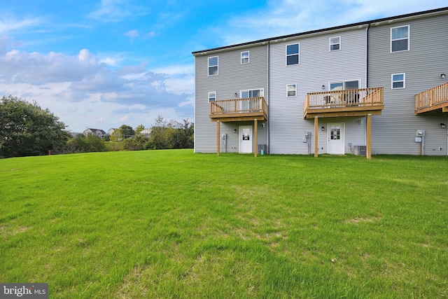 rear view of property with a yard