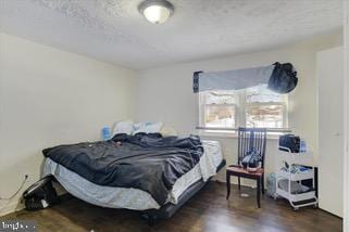 bedroom featuring dark hardwood / wood-style flooring