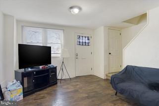 living room with dark wood-type flooring