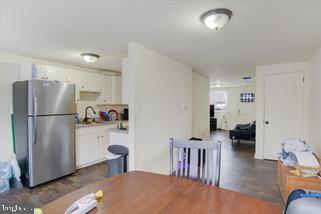 dining room featuring sink and dark wood-type flooring