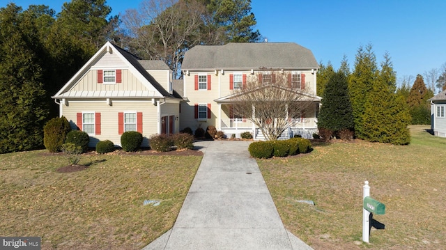 view of front of home with covered porch and a front lawn