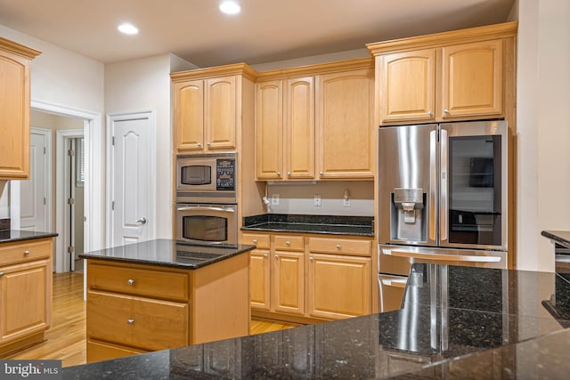 kitchen featuring a kitchen island, light brown cabinets, stainless steel appliances, and light hardwood / wood-style floors