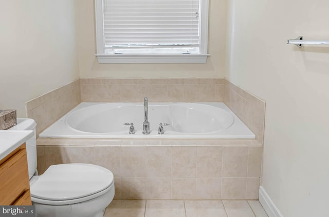 bathroom featuring toilet, vanity, tile patterned flooring, and a relaxing tiled tub