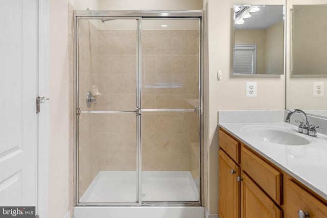 bathroom with walk in shower and vanity