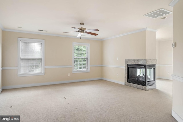 unfurnished living room featuring light carpet, ceiling fan, ornamental molding, and a multi sided fireplace