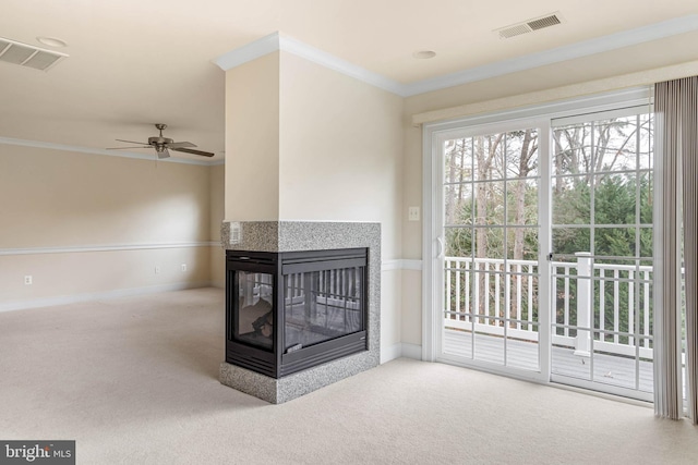 living room with a multi sided fireplace, carpet floors, crown molding, and ceiling fan