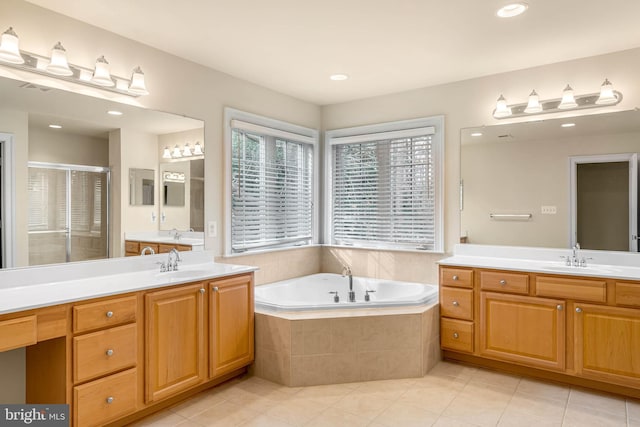 bathroom featuring plus walk in shower, tile patterned flooring, and vanity