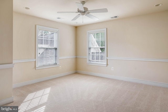 unfurnished room featuring ceiling fan and light colored carpet