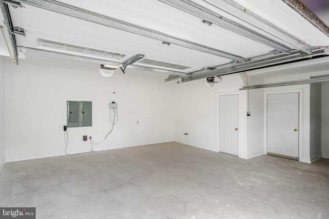 garage with a garage door opener and electric panel