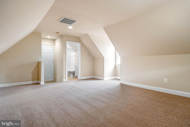 additional living space featuring carpet and lofted ceiling