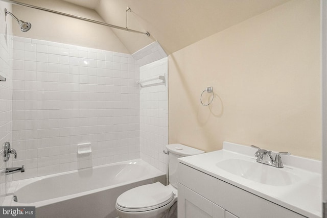 full bathroom with tub / shower combination, toilet, vanity, and vaulted ceiling