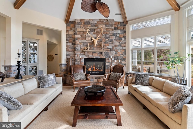 carpeted living room with high vaulted ceiling, a fireplace, and beamed ceiling