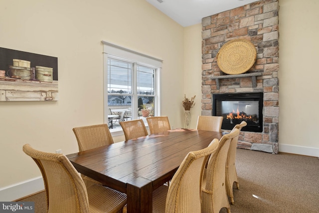 dining area with carpet floors and a fireplace