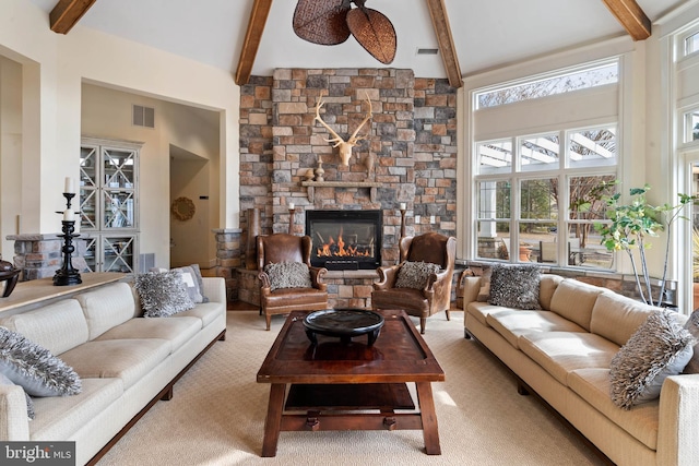 31793 Marsh Island Ave, Lewes, DE 19958 - carpeted living area featuring beamed ceiling, visible vents, a stone fireplace, and a towering ceiling