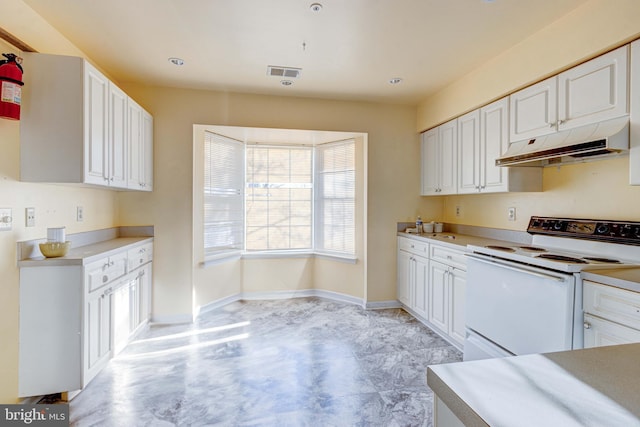 kitchen with white cabinetry and white electric range oven