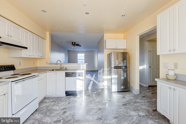 kitchen with white appliances, white cabinets, sink, kitchen peninsula, and ceiling fan