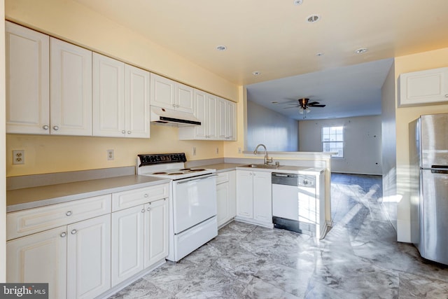 kitchen featuring sink, white appliances, white cabinets, and kitchen peninsula