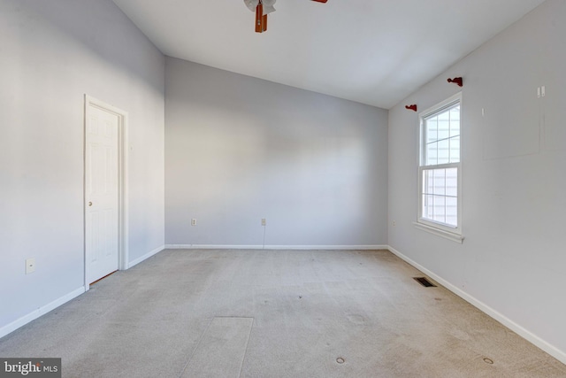 carpeted spare room featuring ceiling fan