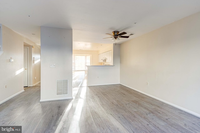 empty room featuring light wood-type flooring and ceiling fan