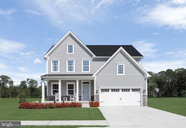 view of front facade featuring a garage, a front lawn, and a porch