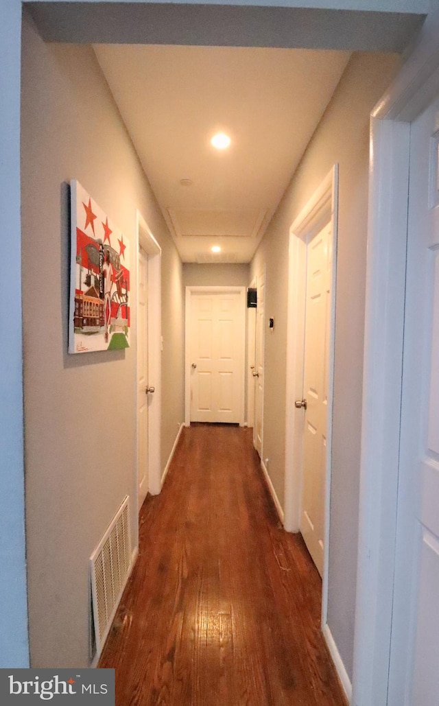 corridor with dark hardwood / wood-style floors