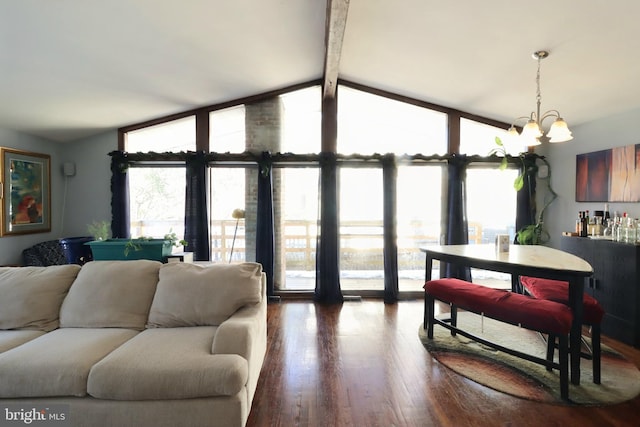 living room featuring hardwood / wood-style flooring, a chandelier, and lofted ceiling with beams