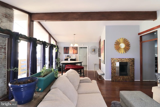 living room with a fireplace, lofted ceiling with beams, a notable chandelier, and dark hardwood / wood-style flooring