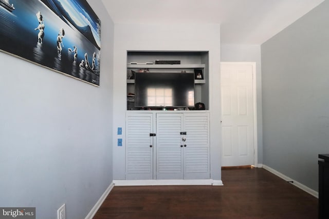 hallway with dark hardwood / wood-style flooring