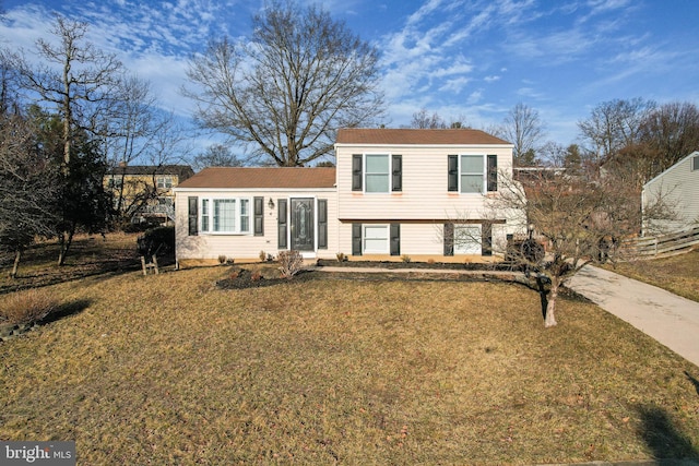 split level home featuring a front lawn