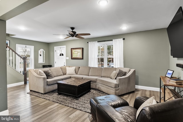 living room with wood-type flooring and ceiling fan