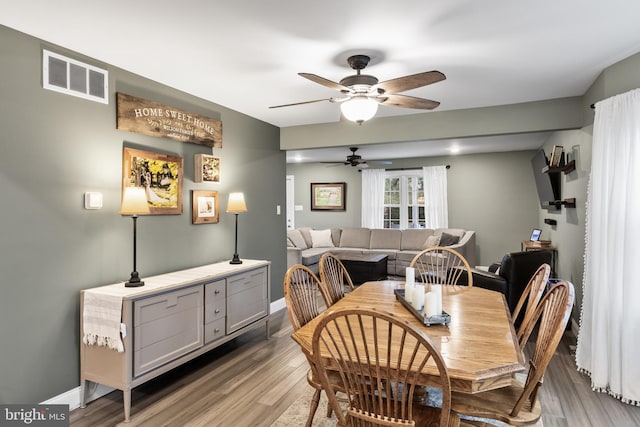 dining area with wood-type flooring and ceiling fan