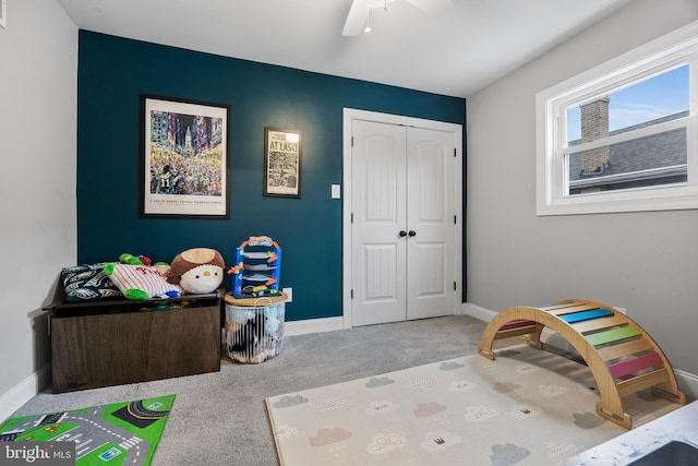 interior space featuring ceiling fan and a closet