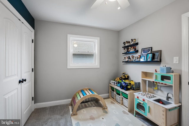 playroom featuring ceiling fan and carpet floors