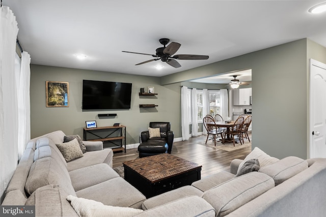 living room featuring ceiling fan and wood-type flooring