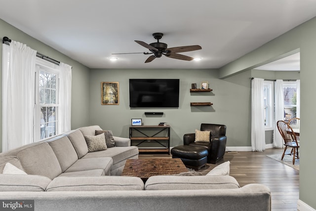 living room featuring hardwood / wood-style floors and ceiling fan