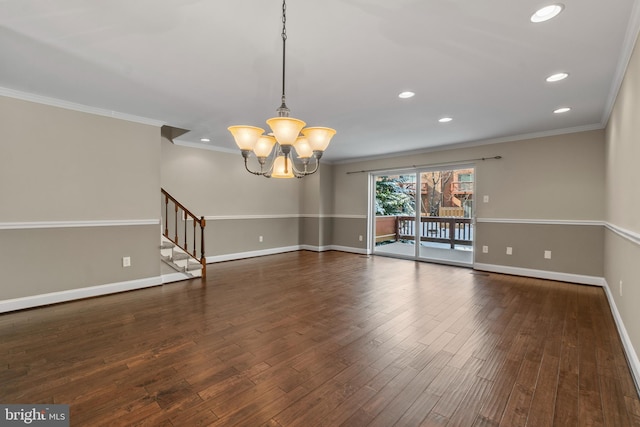 unfurnished room featuring an inviting chandelier, crown molding, and dark hardwood / wood-style floors