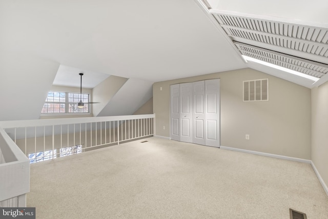 additional living space with carpet floors and lofted ceiling