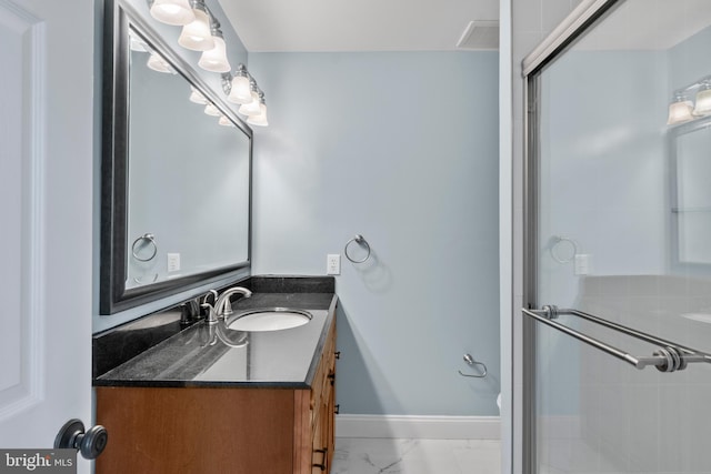 bathroom featuring an enclosed shower and vanity